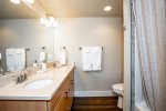 En suite master bath with double sinks and shower tub combo